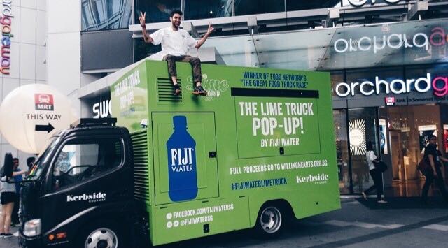 Fiji Water branded food truck wrap by The Lime Truck — international charity activation on Orchard Road, Singapore, supporting WillingHearts